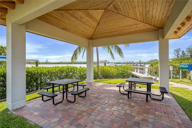 a view of a patio with table and chairs under an umbrella
