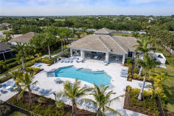 an aerial view of a house with a garden and lake view