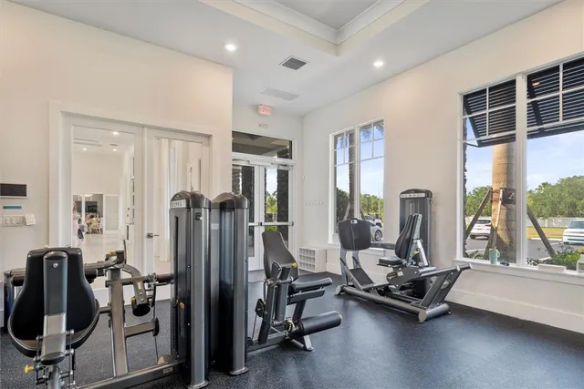 a view of a room with gym equipment and floor to ceiling window