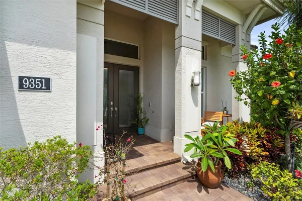 a potted plant sitting in front of a house