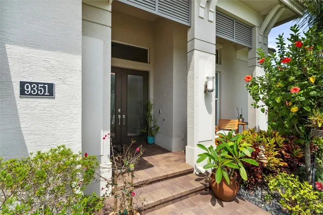 a potted plant sitting in front of a house