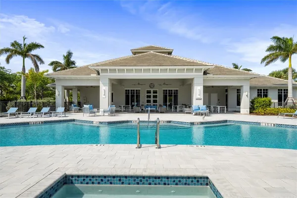 a view of a house with swimming pool and a table and chairs