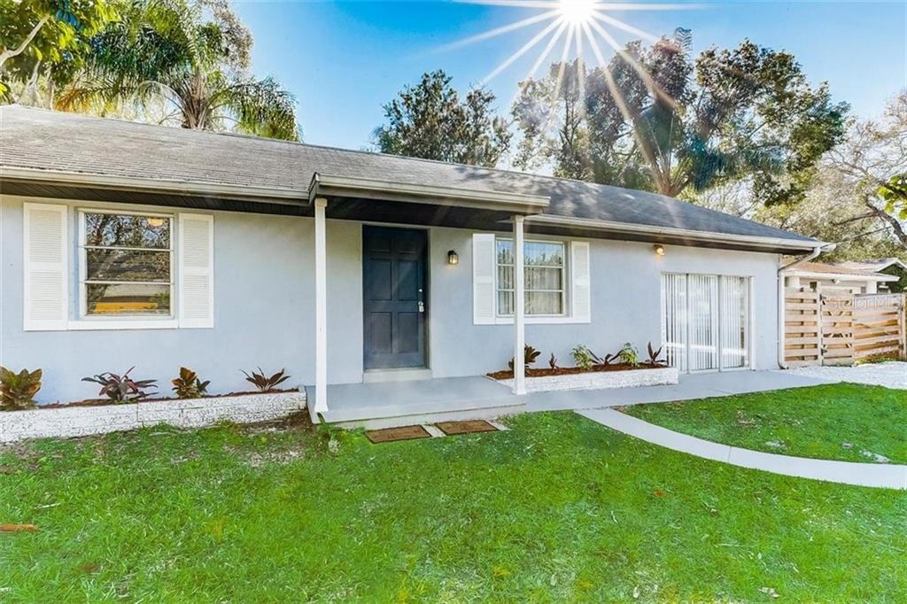 2712 Ashton Road Sarasota, FL 34231 - Photo 1 of 1 a front view of a house with a yard