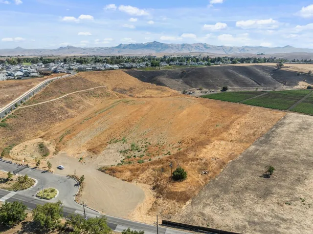 an aerial view of lake and residential houses with outdoor space