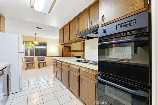 a kitchen with a stove cabinets and counter space