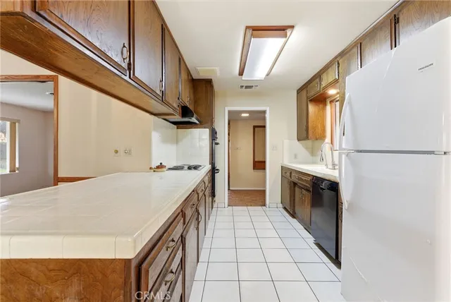 a kitchen with a stove a refrigerator and a cabinets