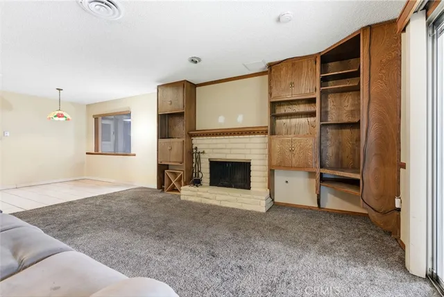 a bed room with a fireplace and cabinet
