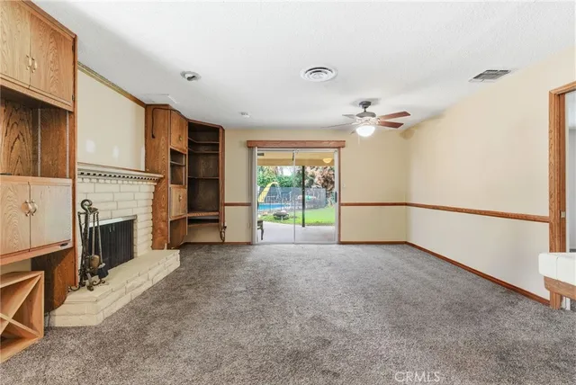 a view of a livingroom with an empty space and a fireplace