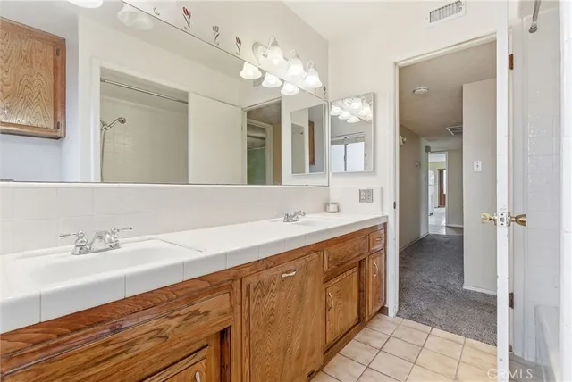a spacious bathroom with a double vanity sink mirror and