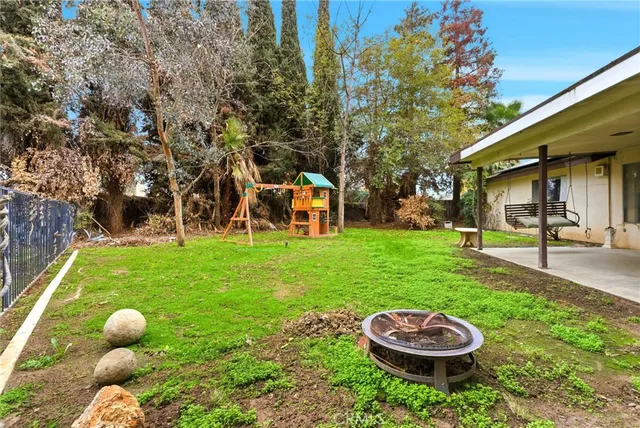 a view of a backyard with plants and a patio