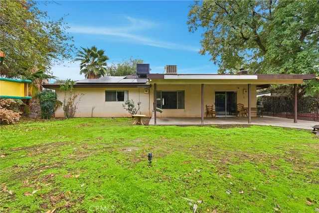 a front view of house with yard and outdoor seating