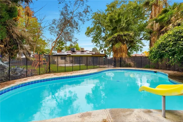 a view of a swimming pool with a patio