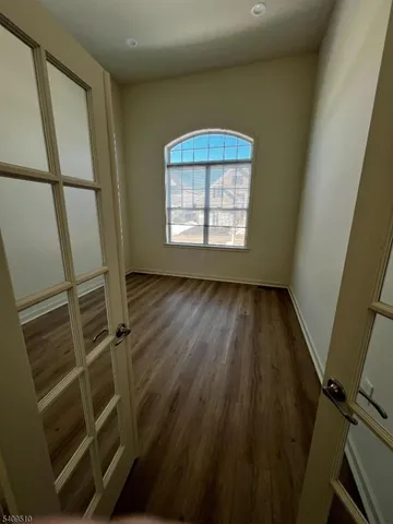 a view of room with window and hardwood floor