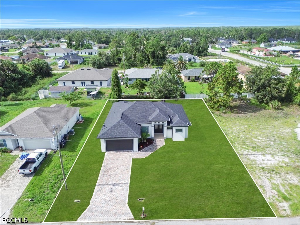 3509 38th Street Southwest Lehigh Acres, FL 33976 - Photo 40 of 47 a view of a garden with an outdoor space