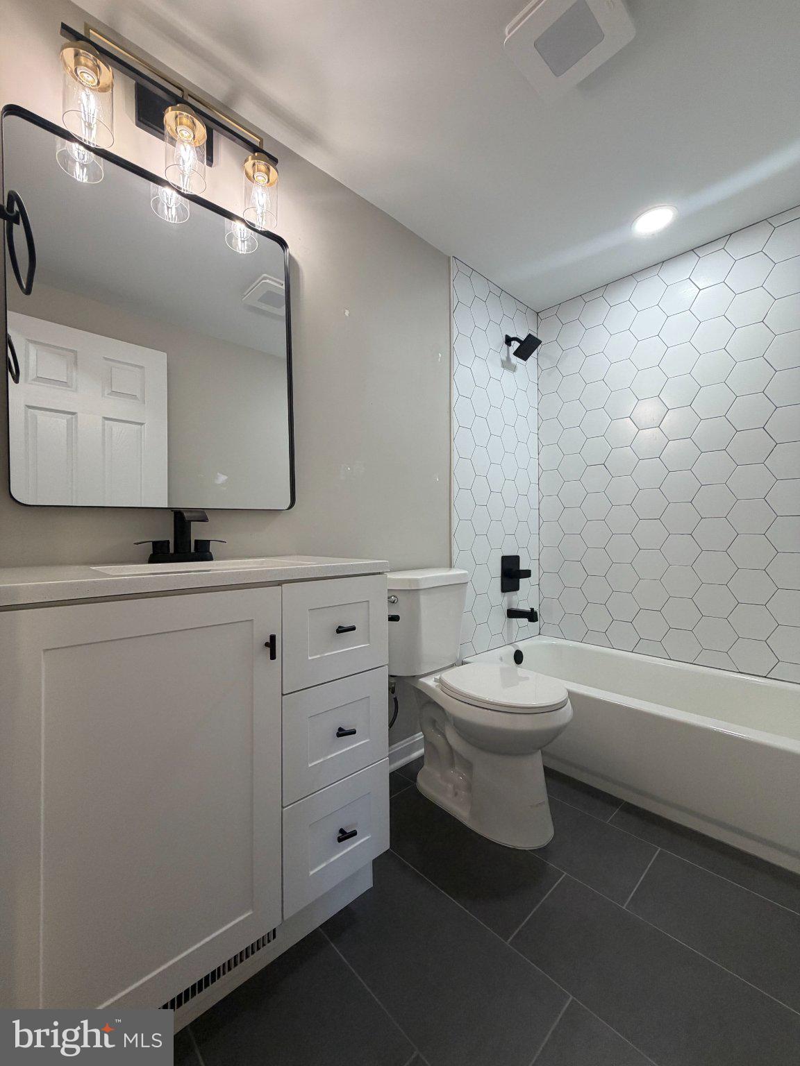 109 Birch Road Stevensville, MD 21666 - Photo 41 of 61 Sleek modern bathroom with hex tiles.