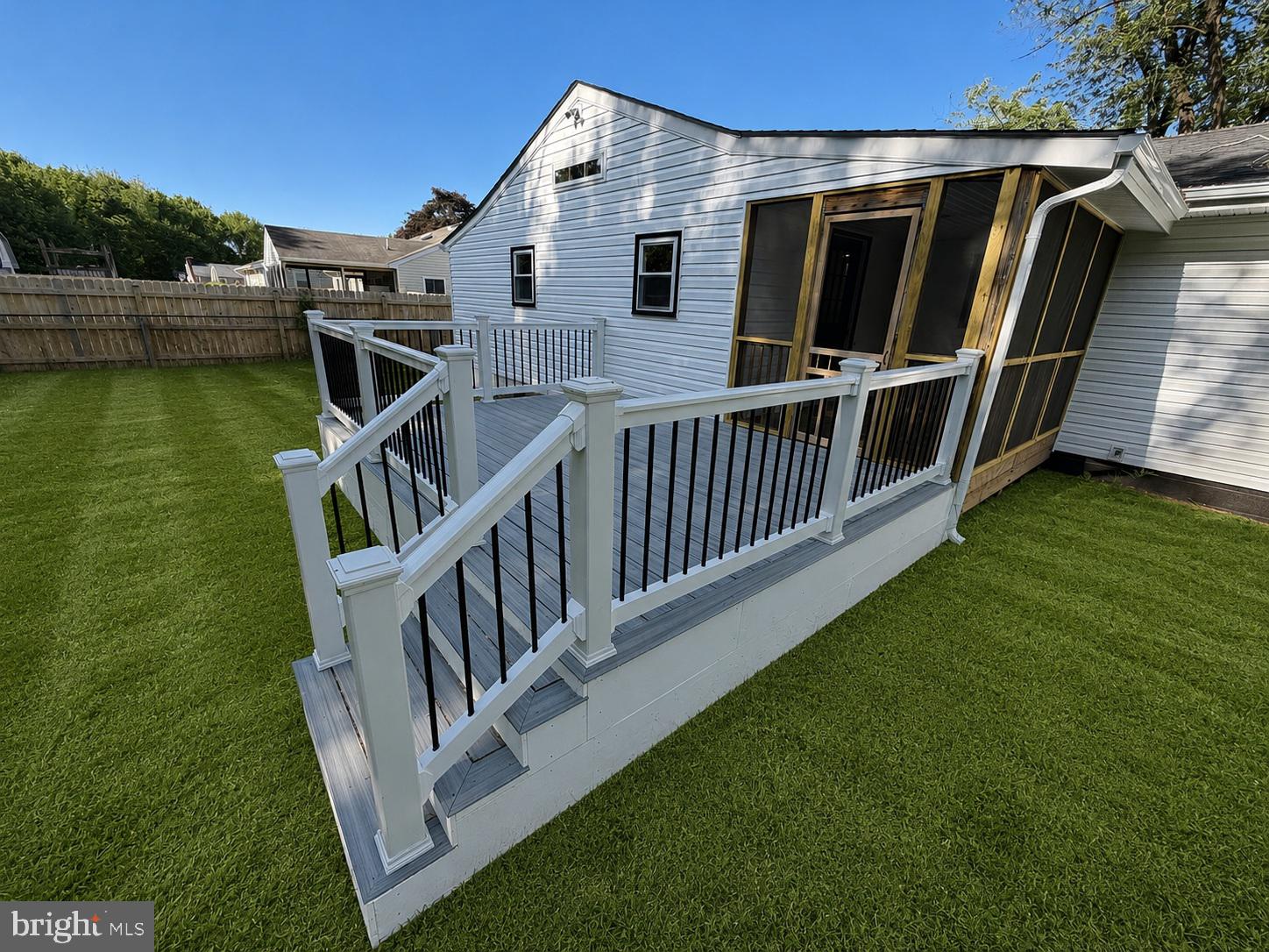 109 Birch Road Stevensville, MD 21666 - Photo 51 of 61 Charming deck with lush green lawn.