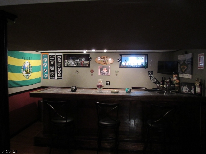 1033 Grove Street North Brunswick, NJ 08902 - Photo 11 of 14 a kitchen with stainless steel appliances a sink dining table and chairs