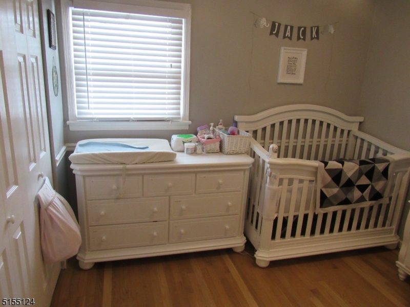 1033 Grove Street North Brunswick, NJ 08902 - Photo 7 of 14 a bedroom with a bed and wooden floor