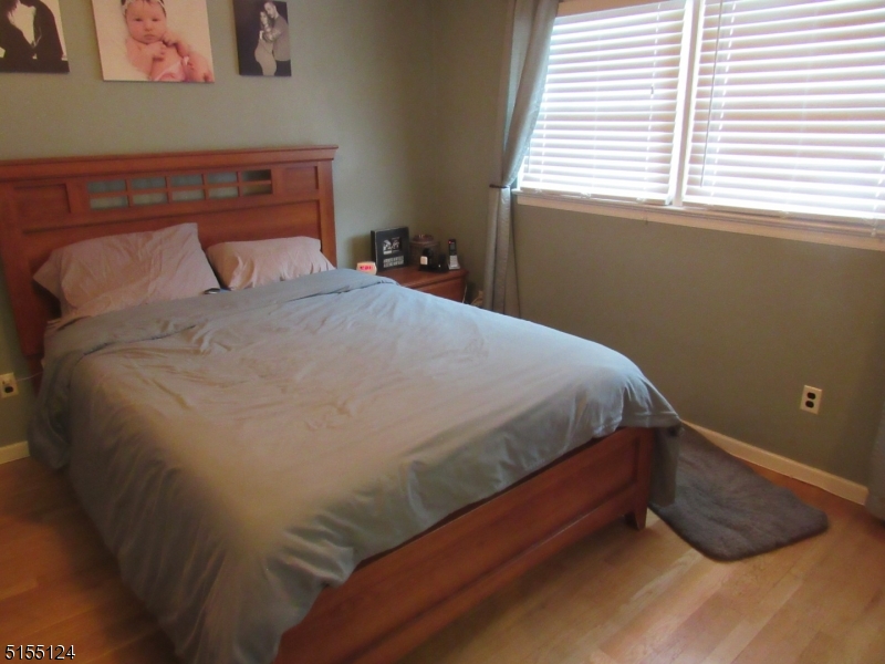 1033 Grove Street North Brunswick, NJ 08902 - Photo 8 of 14 a bed sitting in a bedroom next to a window