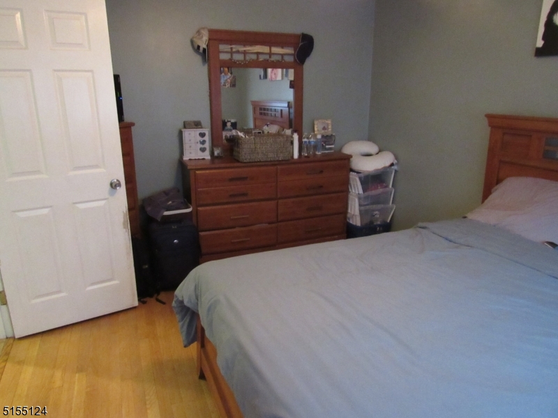1033 Grove Street North Brunswick, NJ 08902 - Photo 9 of 14 a bedroom with a bed and a mirror