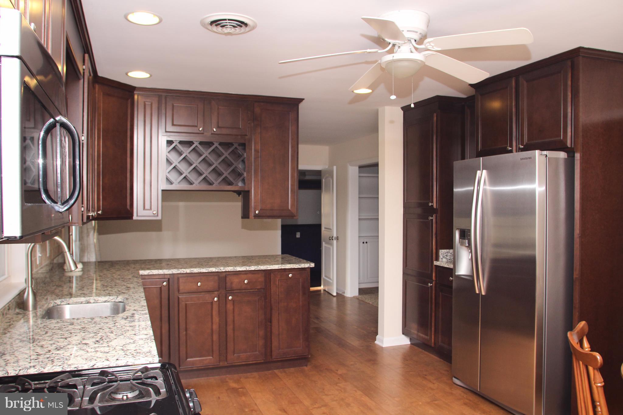 610 Mountain Road Fallston, MD 21047 - Photo 12 of 29 a kitchen with stainless steel appliances granite countertop a refrigerator a sink and a stove