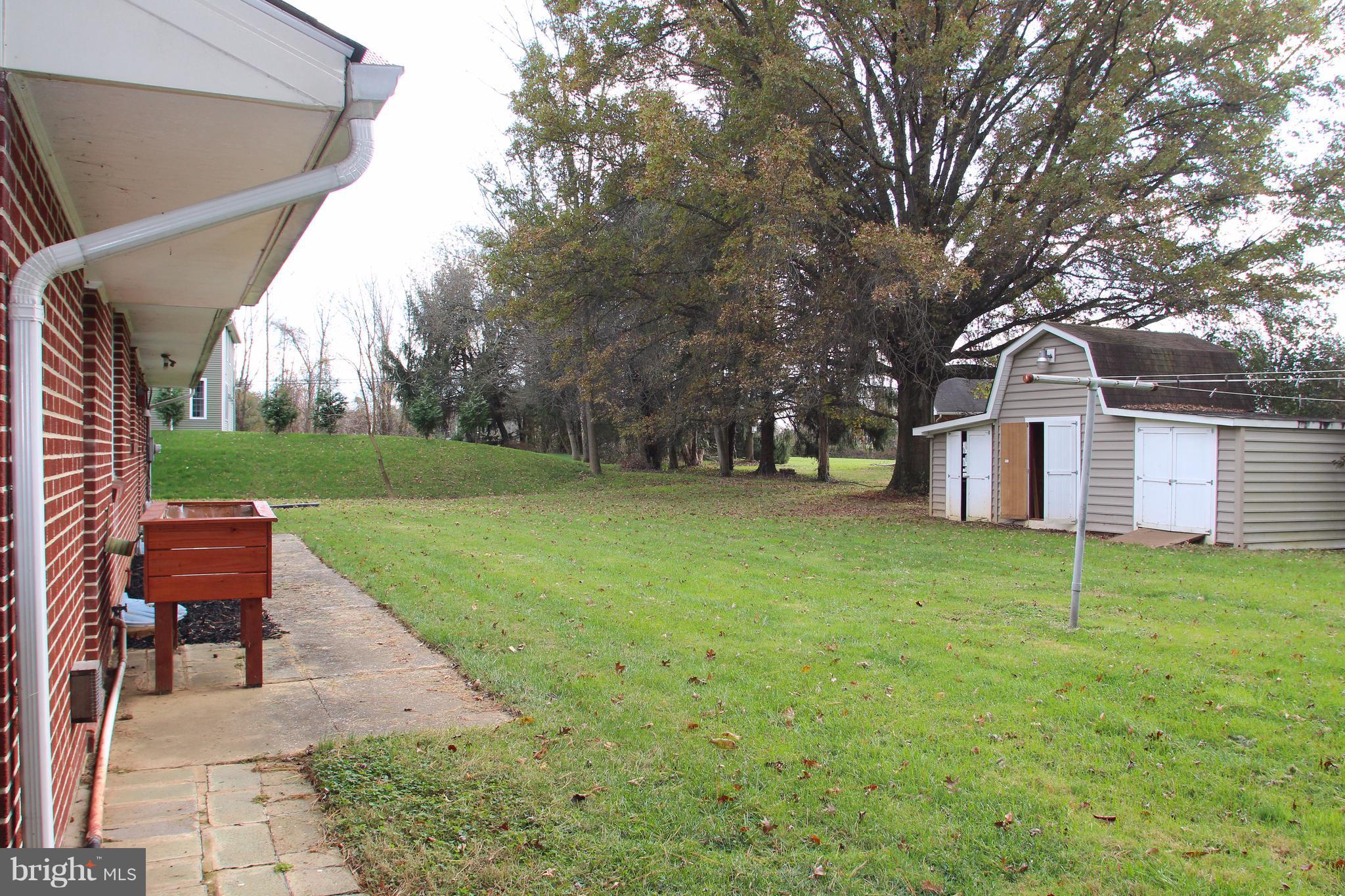 610 Mountain Road Fallston, MD 21047 - Photo 4 of 29 a view of a backyard with table and chairs and a tree