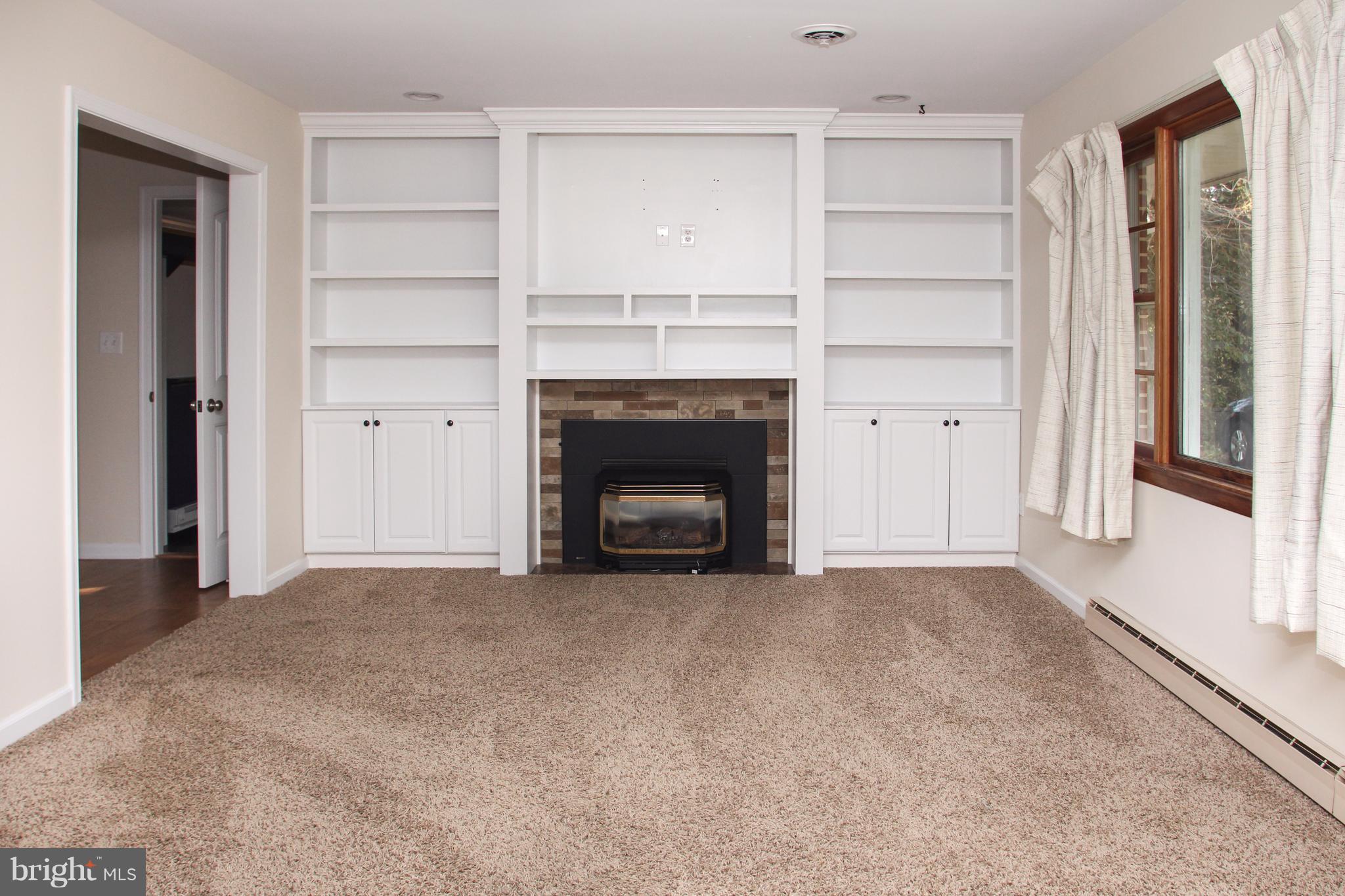 610 Mountain Road Fallston, MD 21047 - Photo 9 of 29 a view of an empty room with a fireplace and a window