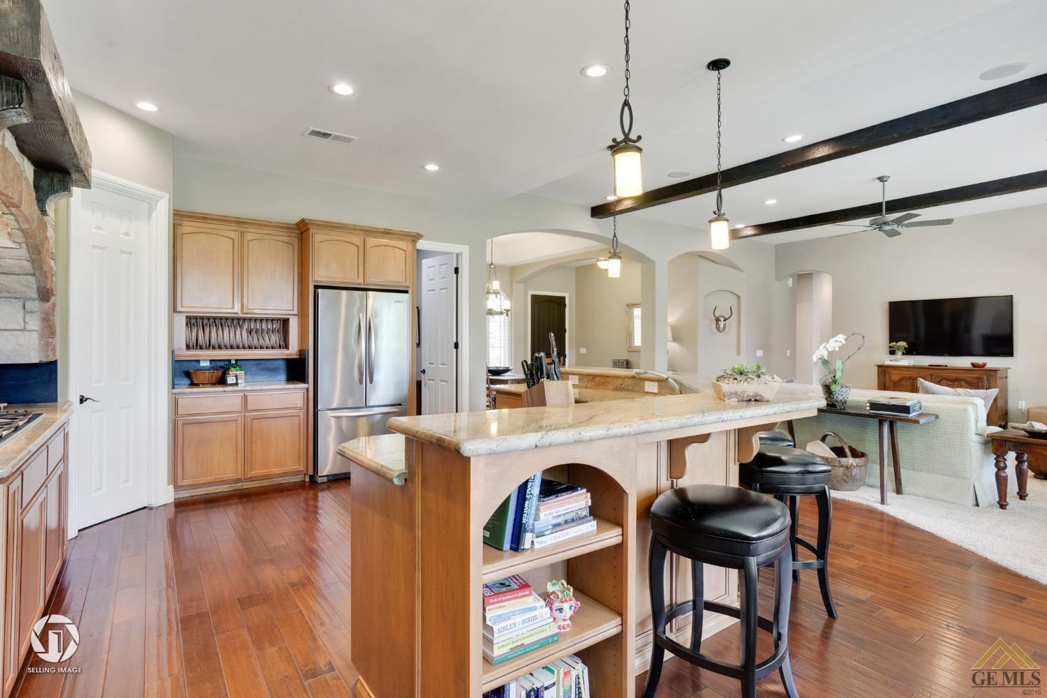 Undisclosed Address Bakersfield, CA 93311 - Photo 22 of 58 a large kitchen with a table and chairs in it