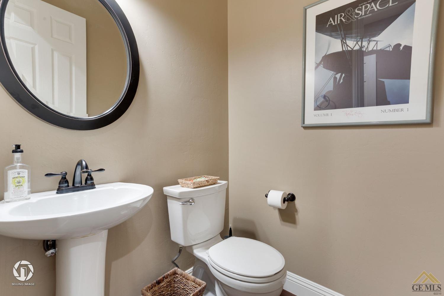 Undisclosed Address Bakersfield, CA 93311 - Photo 32 of 58 a bathroom with a sink mirror and toilet