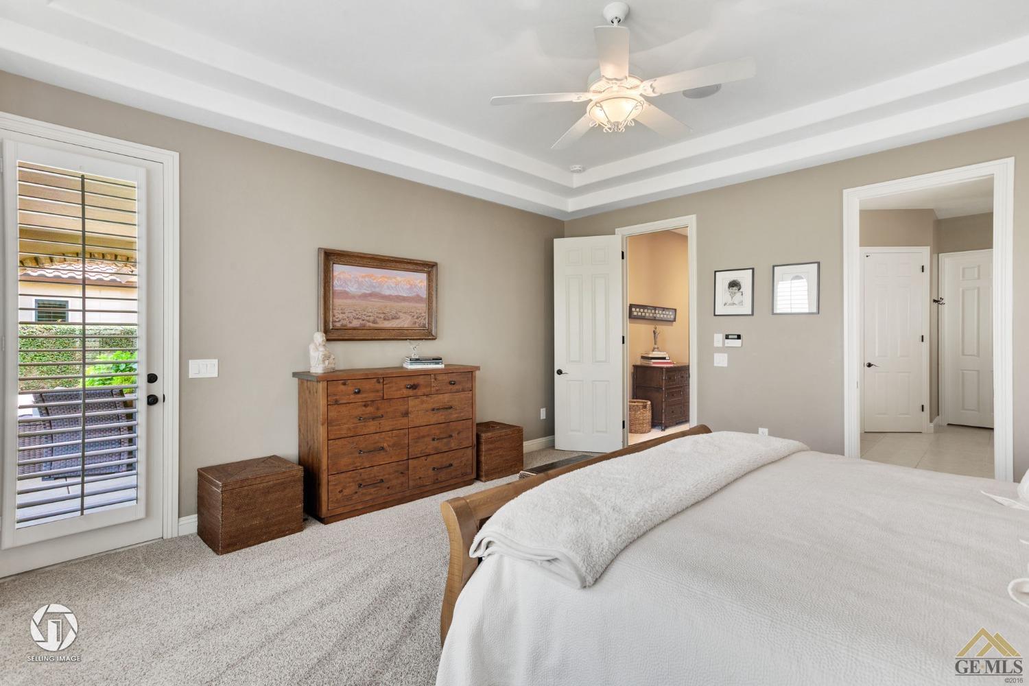 Undisclosed Address Bakersfield, CA 93311 - Photo 37 of 58 a bedroom with a bed and a chandelier