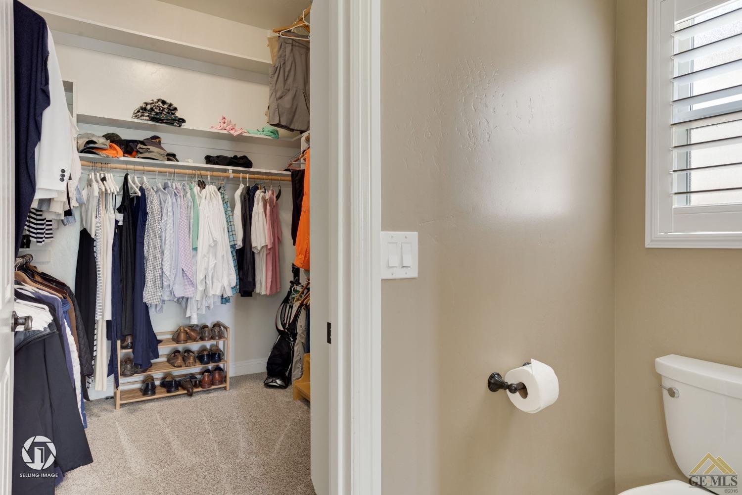 Undisclosed Address Bakersfield, CA 93311 - Photo 39 of 58 a view of walk in closet with clothes and shoes