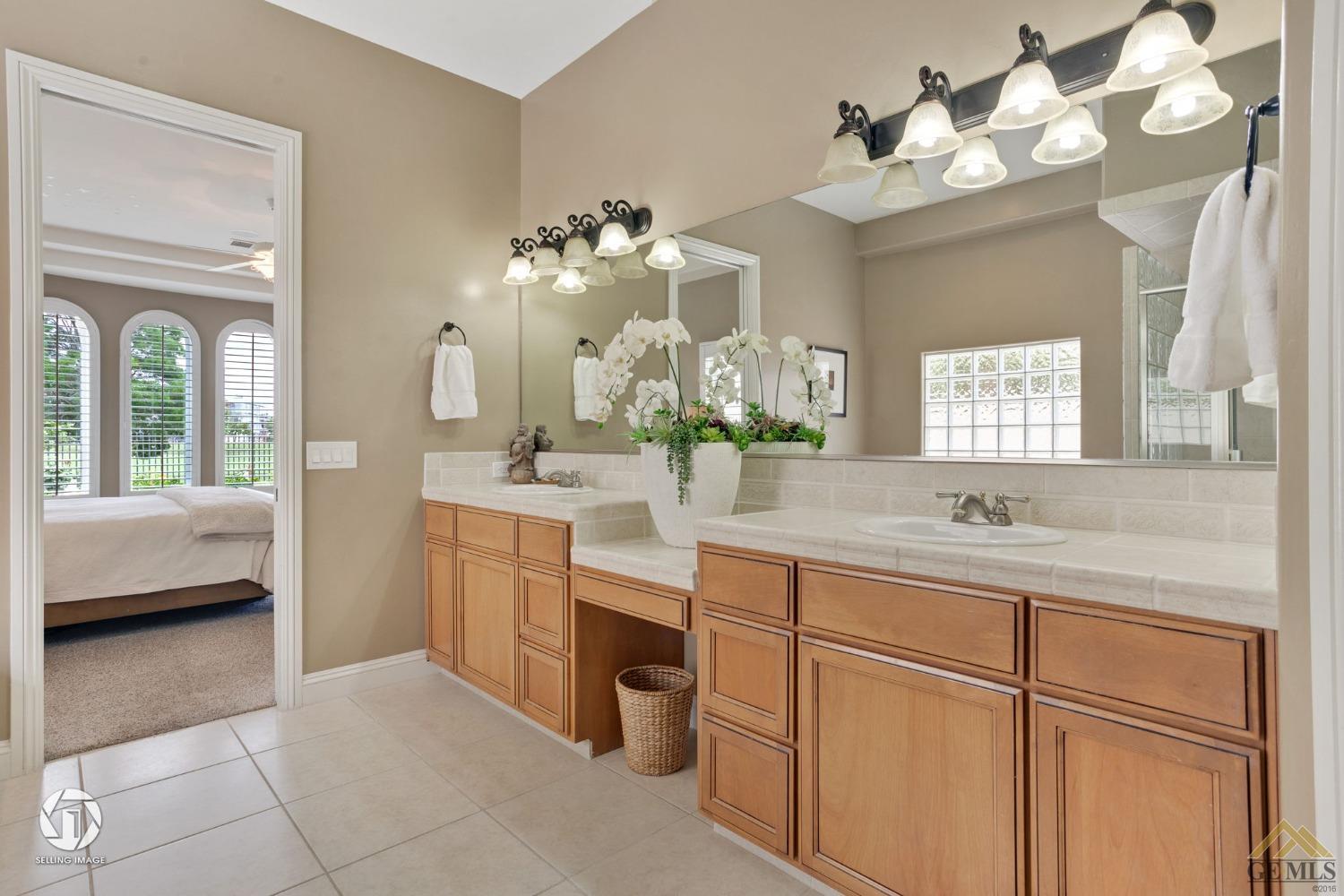Undisclosed Address Bakersfield, CA 93311 - Photo 40 of 58 a bathroom with a sink vanity and a mirror