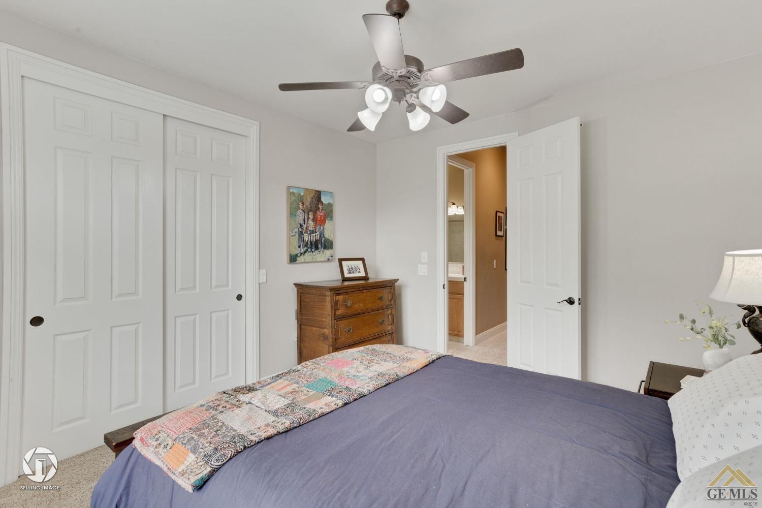 Undisclosed Address Bakersfield, CA 93311 - Photo 45 of 58 a bedroom with a bed and a chandelier