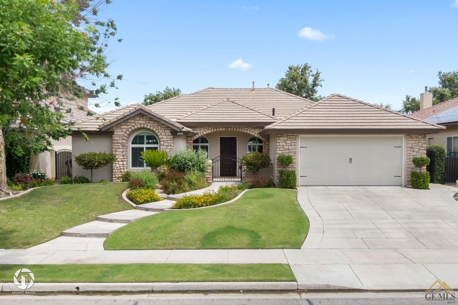 Undisclosed Address Bakersfield, CA 93311 - Photo 7 of 58 a front view of a house with a yard
