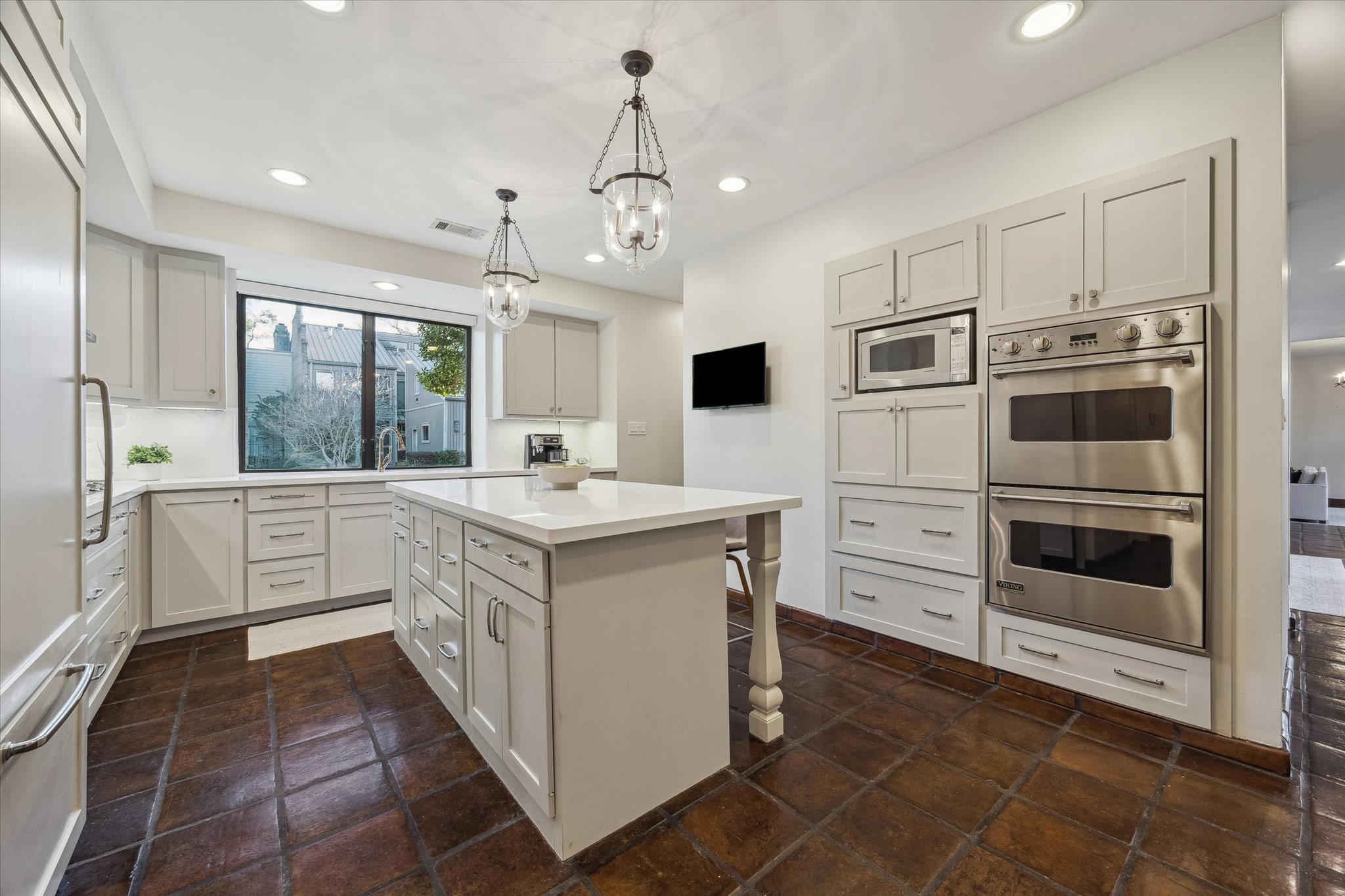 10818 Pepper Lane Houston, TX 77079 - Photo 12 of 34 The kitchen features an island with quartzite countertops