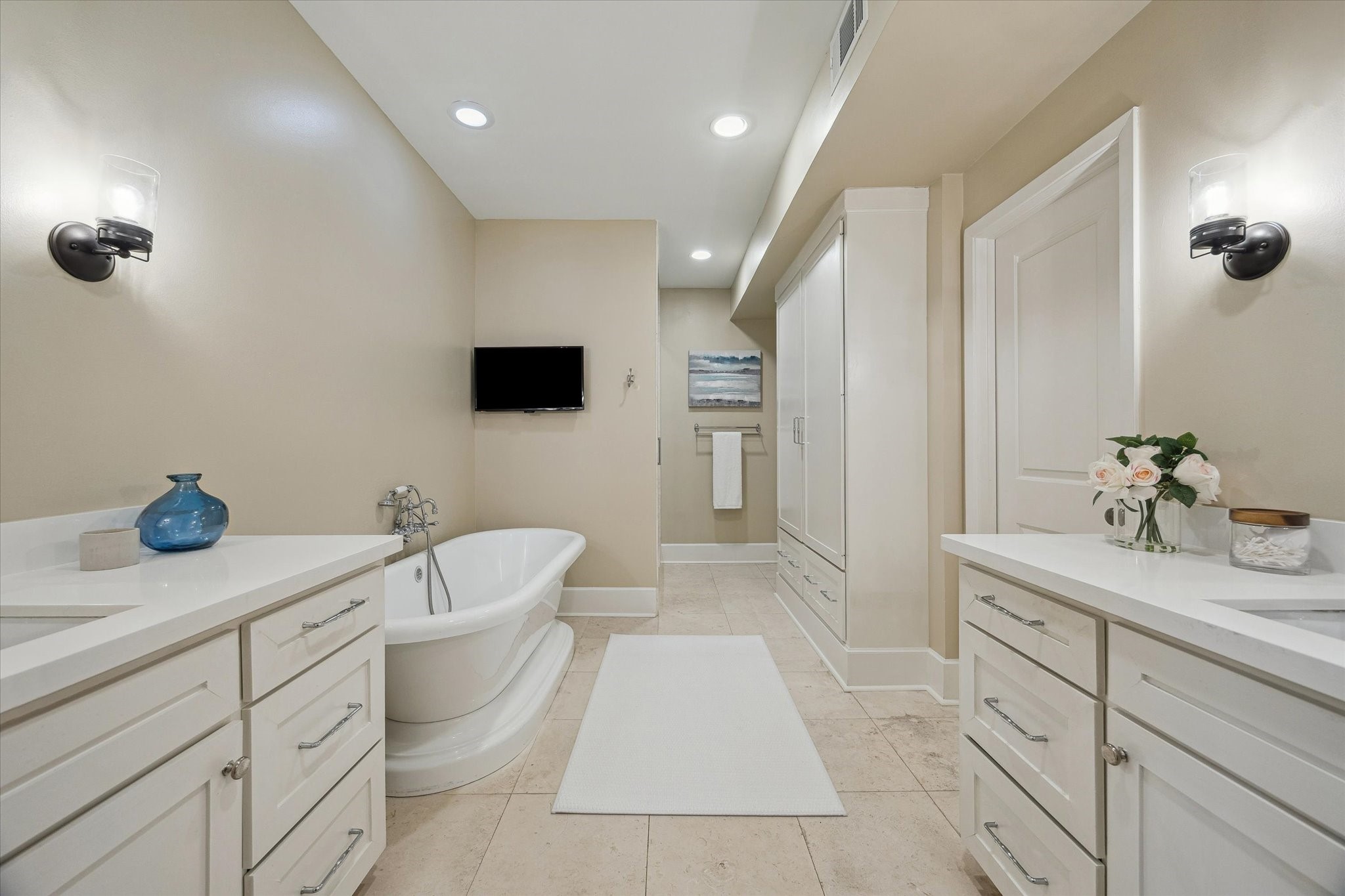 10818 Pepper Lane Houston, TX 77079 - Photo 17 of 34 The primary bathroom features stone countertops, double sinks, and ample storage below