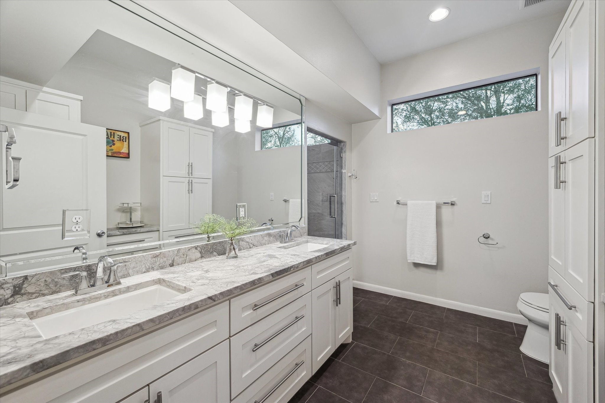 10818 Pepper Lane Houston, TX 77079 - Photo 24 of 34 The bathroom for the upstairs primary suite features double sinks and a separate glass-enclosed shower