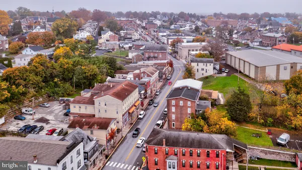 an aerial view of residential houses with city view