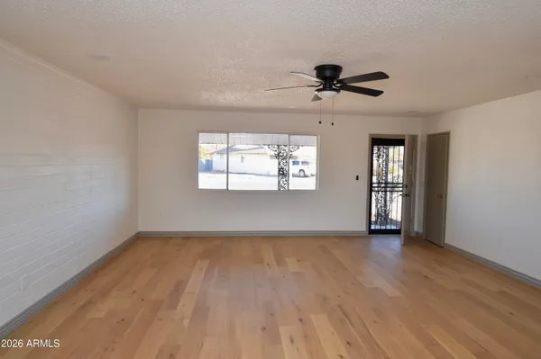 wooden floor in an empty room with a window