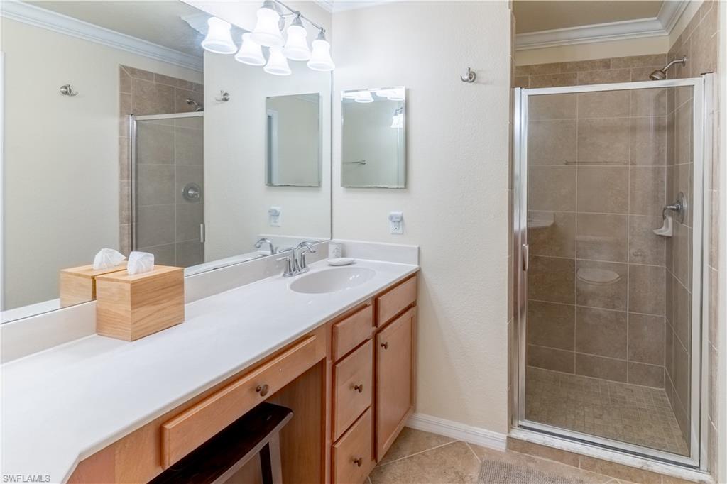9517 Avellino Way, Unit 2214 Naples, FL 34113 - Photo 11 of 44 a bathroom with a sink and a mirror