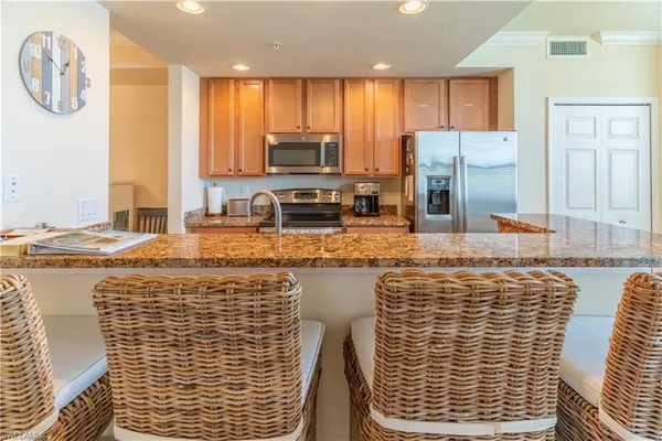 a kitchen with stainless steel appliances granite countertop a sink and a granite counter tops