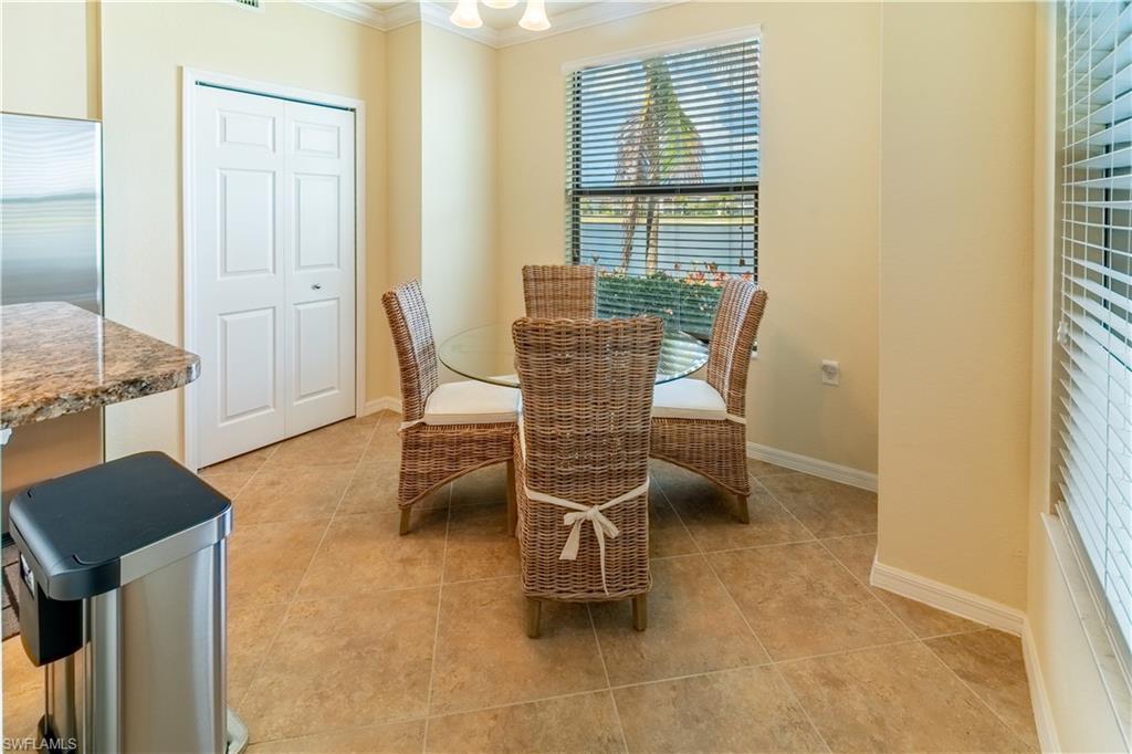 9517 Avellino Way, Unit 2214 Naples, FL 34113 - Photo 16 of 44 a dining room with furniture and a window