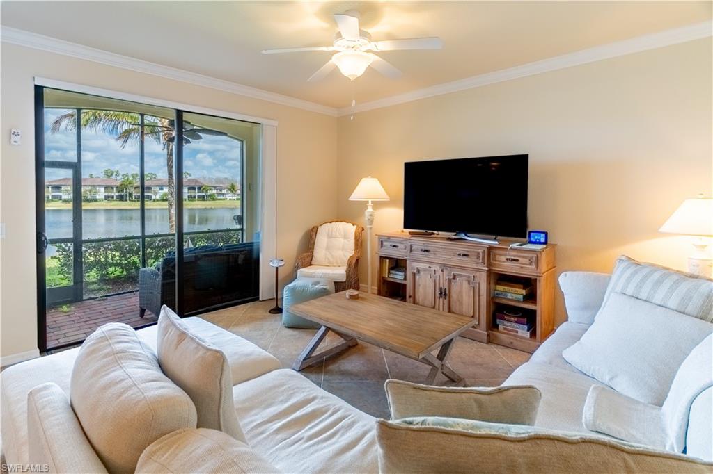 9517 Avellino Way, Unit 2214 Naples, FL 34113 - Photo 18 of 44 a living room with furniture and a flat screen tv