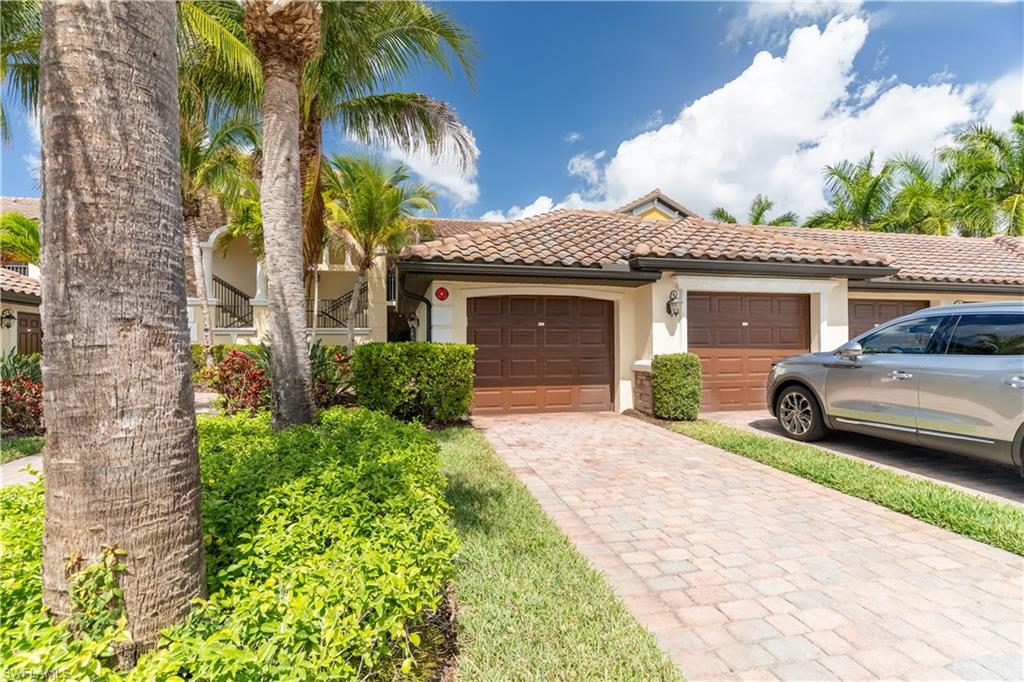 9517 Avellino Way, Unit 2214 Naples, FL 34113 - Photo 23 of 44 a front view of a house with a garden