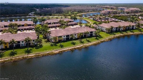 an aerial view of residential houses with outdoor space and river