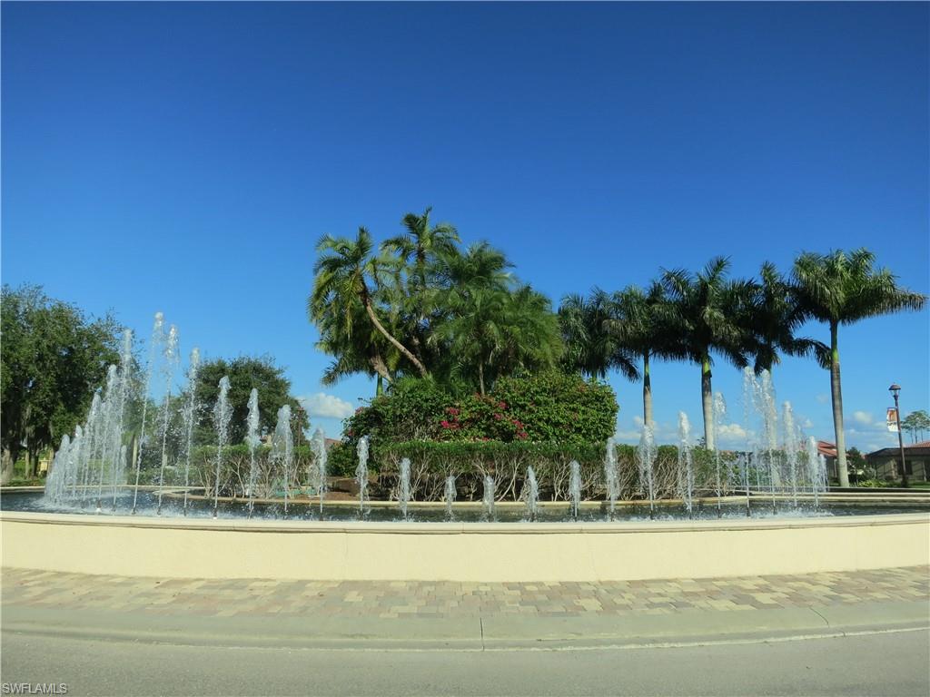 9517 Avellino Way, Unit 2214 Naples, FL 34113 - Photo 43 of 44 a view of a yard and palm trees
