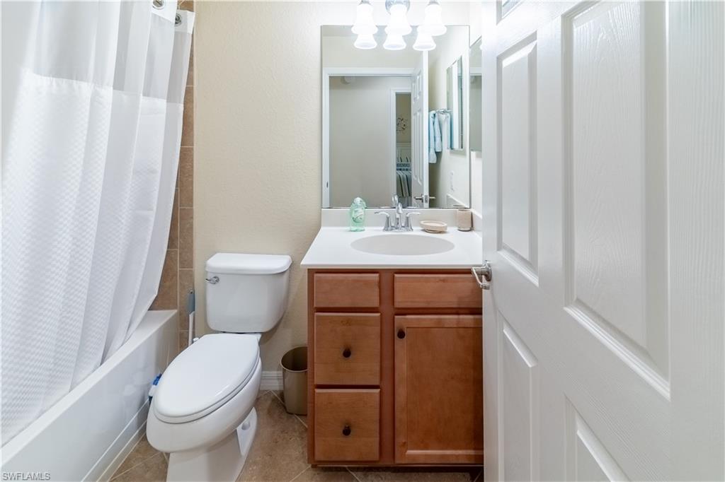 9517 Avellino Way, Unit 2214 Naples, FL 34113 - Photo 6 of 44 a bathroom with a toilet sink and mirror