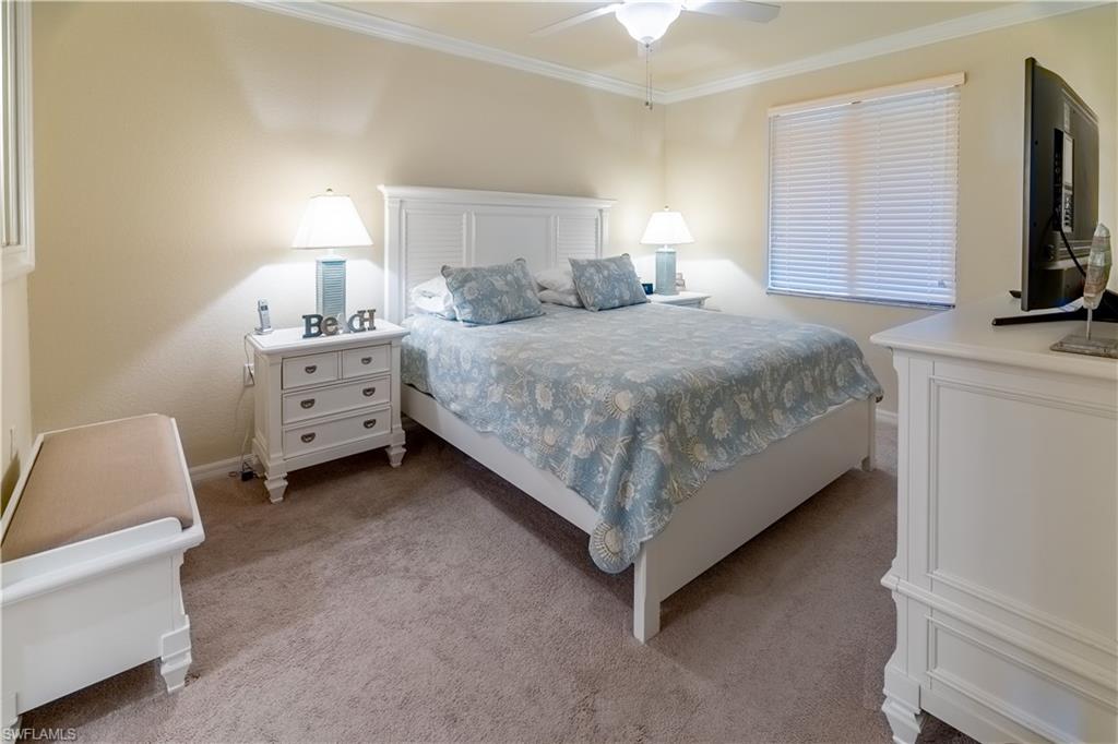 9517 Avellino Way, Unit 2214 Naples, FL 34113 - Photo 7 of 44 a bedroom with a bed and a flat screen tv