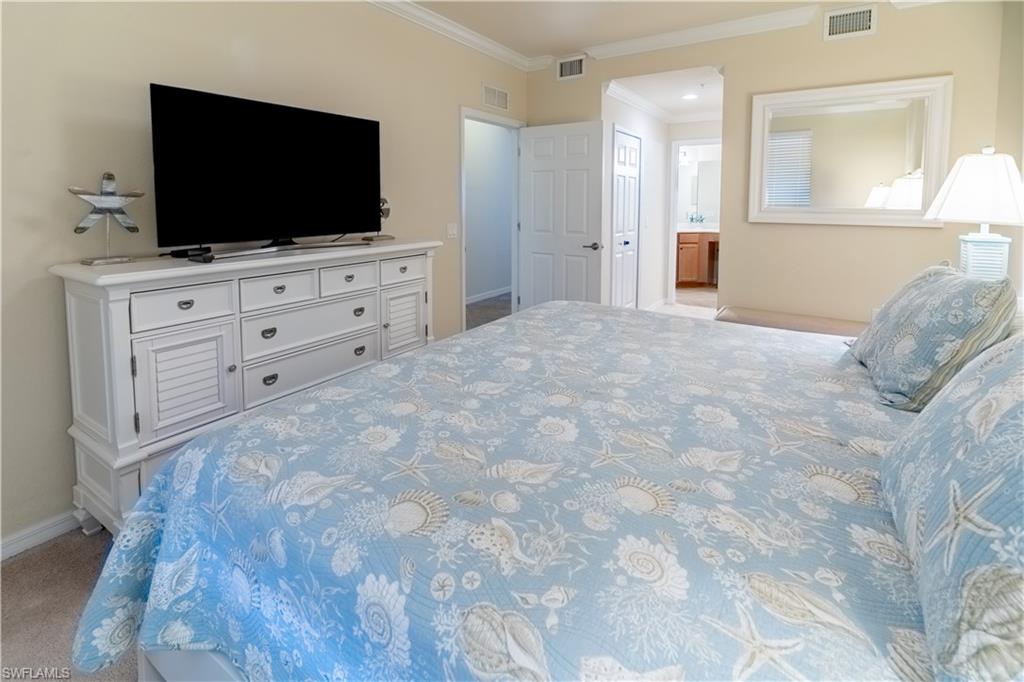 9517 Avellino Way, Unit 2214 Naples, FL 34113 - Photo 8 of 44 a room with furniture and flat screen tv