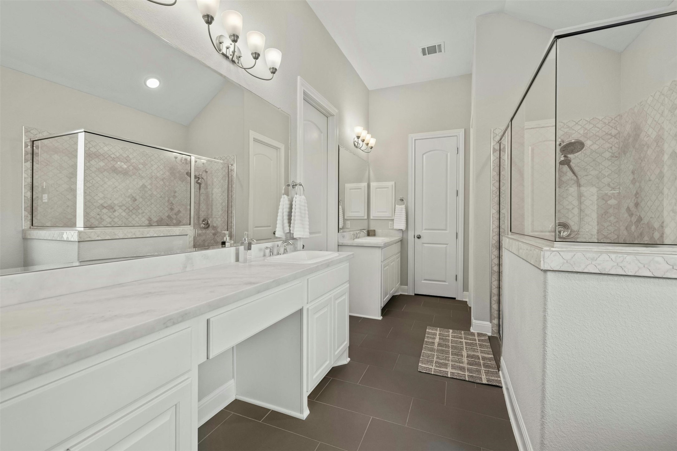 1820 Ficuzza Way Leander, TX 78641 - Photo 8 of 35 The custom en-suite bath includes separate vanities. An oversized walk-in shower is
adorned with designer mosaic
marble tile.
